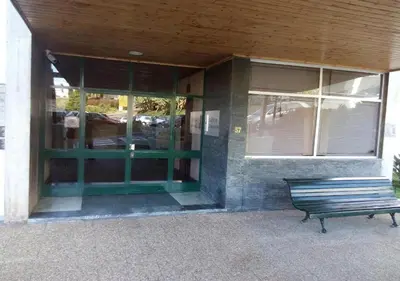 a bench in front of a building with windows at Atlantic View Free Parking in Funchal