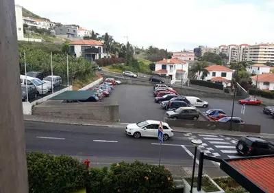 a parking lot with a bunch of cars parked at Atlantic View Free Parking in Funchal