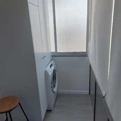 a laundry room with a washing machine next to a window at Atlantic View Free Parking in Funchal