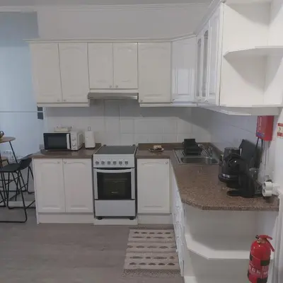 a kitchen with white cabinets and a stove top oven at Atlantic View Free Parking in Funchal