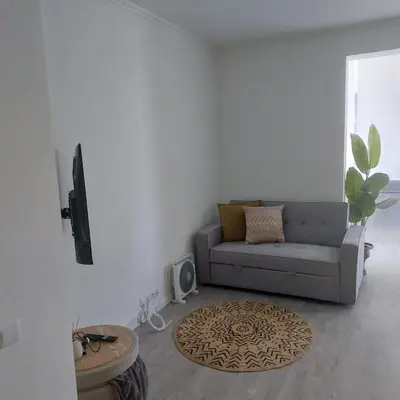 a living room with a couch and a rug at Atlantic View Free Parking in Funchal