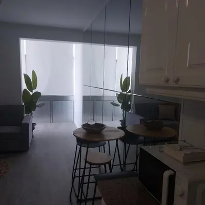 a living room with two tables and some plants at Atlantic View Free Parking in Funchal