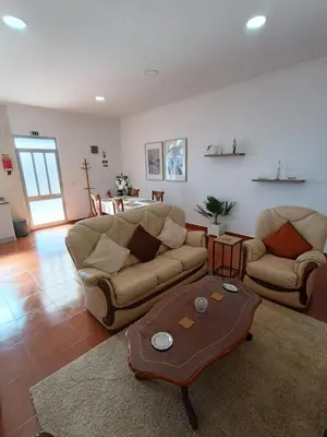 a living room with a couch and a coffee table at my flower in Ponta do Sol