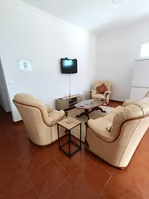 a living room with two couches and a tv at my flower in Ponta do Sol