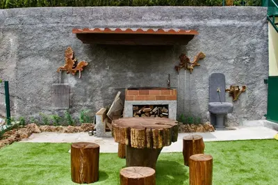 a garden with a fireplace in a yard with logs at Hera House, Ponta do Sol, Portugal in Canhas