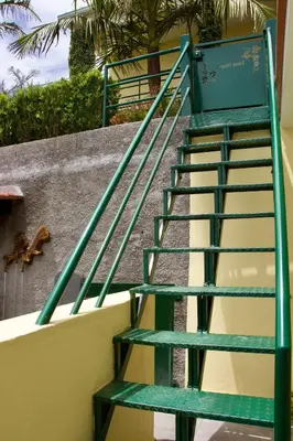 a green staircase leading up to a building at Hera House, Ponta do Sol, Portugal in Canhas