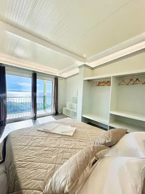 a large bedroom with a large bed with a large window at Hera House, Ponta do Sol, Portugal in Canhas