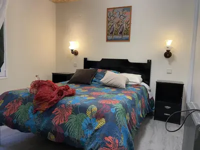 a bedroom with a bed with a colorful comforter at Casadarvore in Ponta Delgada