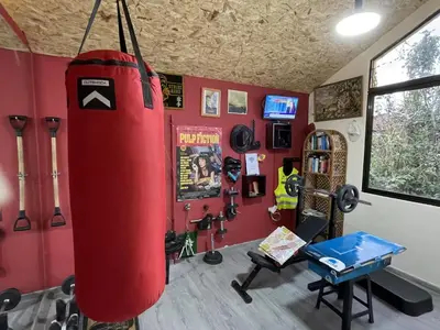a gym with a punching bag hanging from the wall at Casadarvore in Ponta Delgada