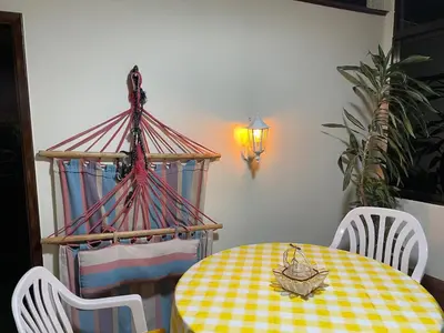a dining room table with a yellow and white checkered table cloth at Casadarvore in Ponta Delgada