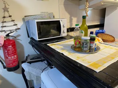 a microwave sitting on top of a kitchen counter at Casadarvore in Ponta Delgada