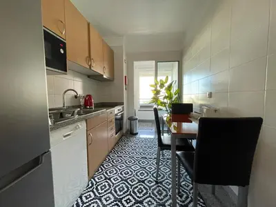 a kitchen with a table and chairs in a room at Forum Palace Madeira in Funchal