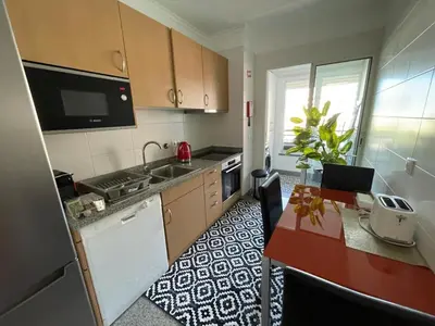 a kitchen with a sink and a stove top oven at Forum Palace Madeira in Funchal