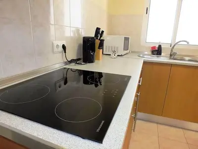 a kitchen with a sink and a counter top at Cozy Private Apartment Calheta in Arco da Calheta
