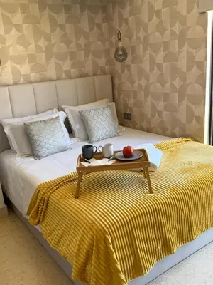 a bed with a tray of food on top of it at Home Funchal Personal 3 in Funchal