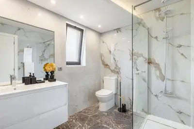 a bathroom with a toilet and a glass shower at Home Funchal Personal 3 in Funchal