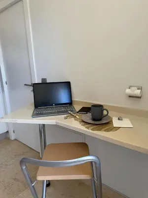 a laptop computer sitting on a desk with a chair at Home Funchal Personal 3 in Funchal