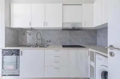 a white kitchen with a sink and a dishwasher at Home Funchal Personal 3 in Funchal