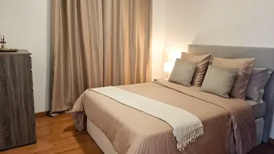 a bedroom with a large bed with pillows at Mãe de Deus - Caniço - Madeira in Caniço