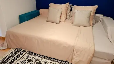 a bed with white sheets and pillows on it at Mãe de Deus - Caniço - Madeira in Caniço