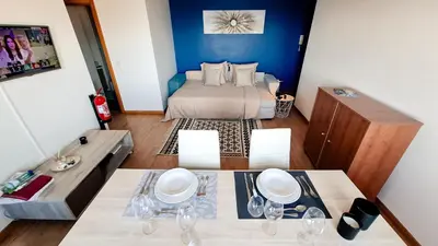 a room with a bed and a table with chairs at Mãe de Deus - Caniço - Madeira in Caniço