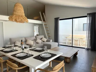 a living room with a table and a couch at Casa Tonel in Bordeira
