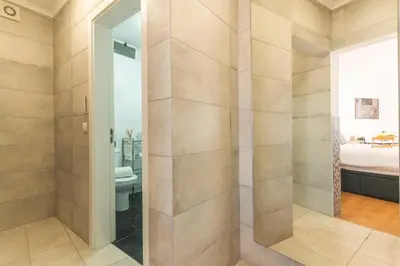 a bathroom with a shower with a toilet and a bed at Casa dos Vinhos by Atlantic Holiday in Santa Maria Maior