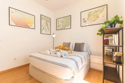 a bedroom with a bed with white sheets at Casa dos Vinhos by Atlantic Holiday in Santa Maria Maior