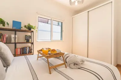 a living room with a bed and a table at Casa dos Vinhos by Atlantic Holiday in Santa Maria Maior