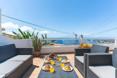 a tray of food on a table on a balcony at Casa dos Vinhos by Atlantic Holiday in Santa Maria Maior