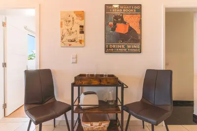 two chairs and a table in a room at Casa dos Vinhos by Atlantic Holiday in Santa Maria Maior