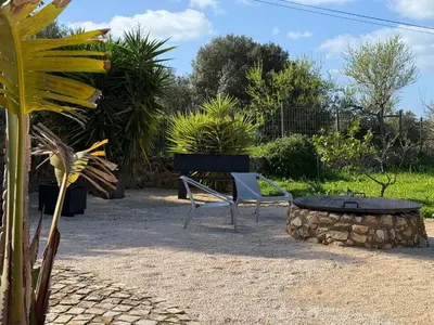 two blue chairs sitting in the grass at night at Casa de campo com vista extraordinária - Casa Isabel in Luz