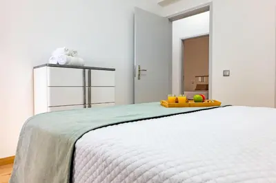 a bedroom with a bed with a tray of fruit on it at Residential Camacho, By OP in Funchal