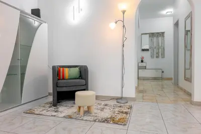 a living room with a chair and a stool at Residential Camacho, By OP in Funchal