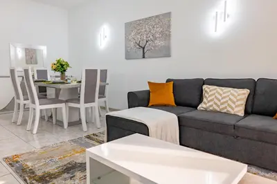 a living room with a couch and a table at Residential Camacho, By OP in Funchal