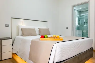 a bed with a tray of fruit on it at Residential Camacho, By OP in Funchal