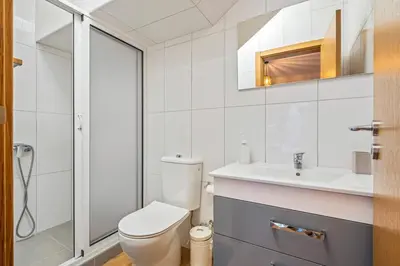 a bathroom with a toilet and a sink at Larano in Funchal