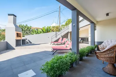 a patio with chairs and stairs on a house at Larano in Funchal