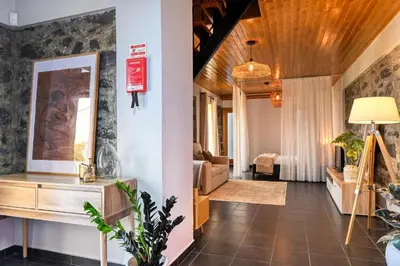 a living room with a couch and a mirror at Valley Canhas I in Canhas