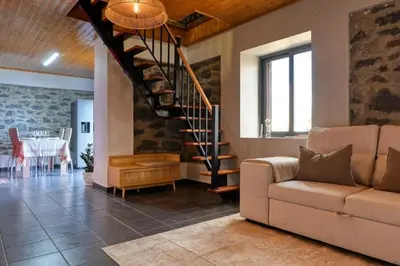 a living room with a couch and a spiral staircase at Valley Canhas I in Canhas