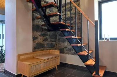a wooden staircase with a bench underneath it at Valley Canhas I in Canhas