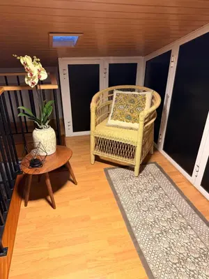a living room with a wicker chair and a table at Valley Canhas I in Canhas