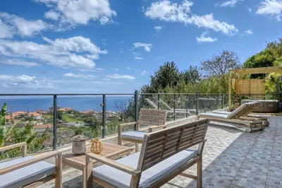 a patio with benches and a view of the ocean at Valley Canhas I in Canhas