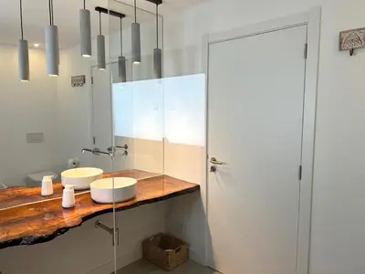 a bathroom with two sinks and a shower at Casa Beliche in Aljezur