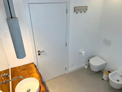 a bathroom with a toilet and a sink at Casa Beliche in Aljezur