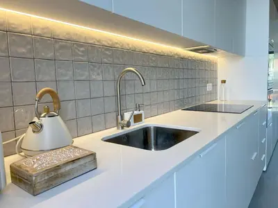 a kitchen with a sink and a kettle on the counter at Casa Telheiro in Aljezur
