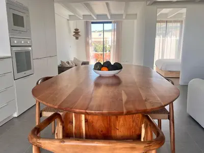 a wooden table in a kitchen with a bowl of fruit on it at Casa Telheiro in Aljezur