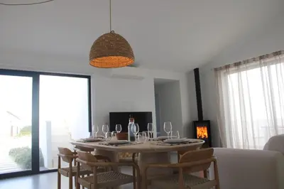 a dining room with a table and some chairs at Casa Mareta in Bordeira