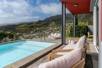 a swimming pool with a view of a city at Vila Venusta by An Island Apart in Calheta