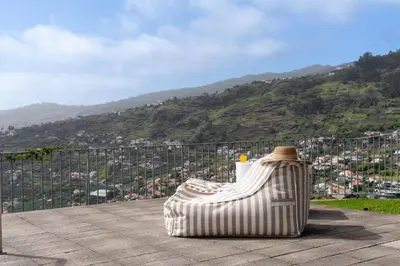 a trash can with a hat sitting on top of a hill at Vila Venusta by An Island Apart in Calheta